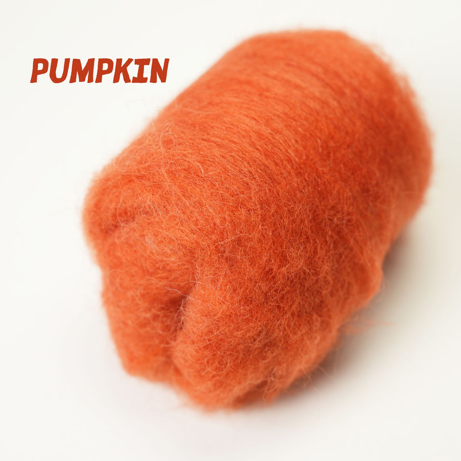 Orange wool roving skein labeled 'Pumpkin' on a white background