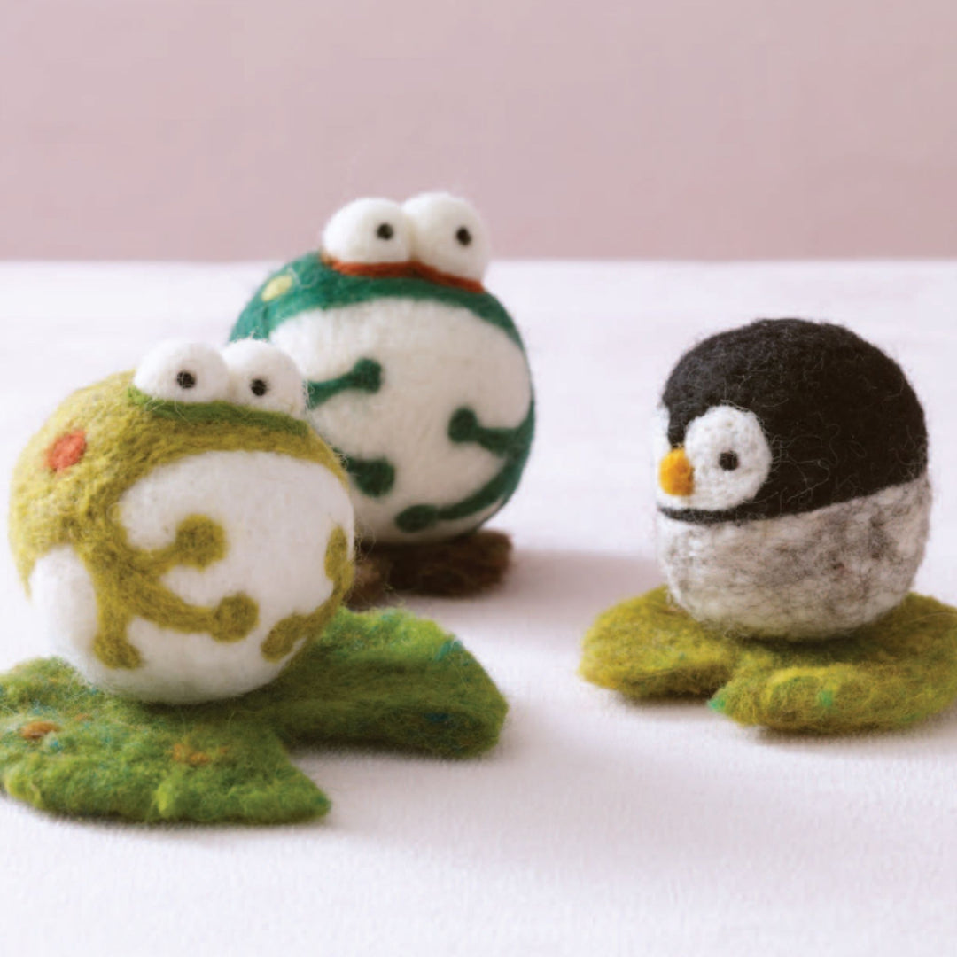 felted frog ornaments and a penguin